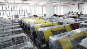 Rows of yellow, red, and gray Xinflying DTF printers are wrapped and prepared for shipment.