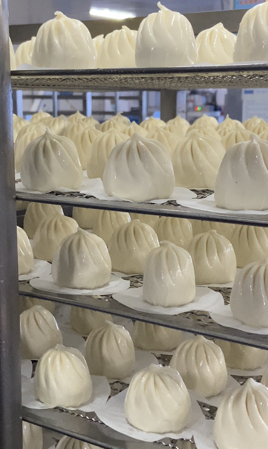Mass production of frozen steamed buns in automated facility
