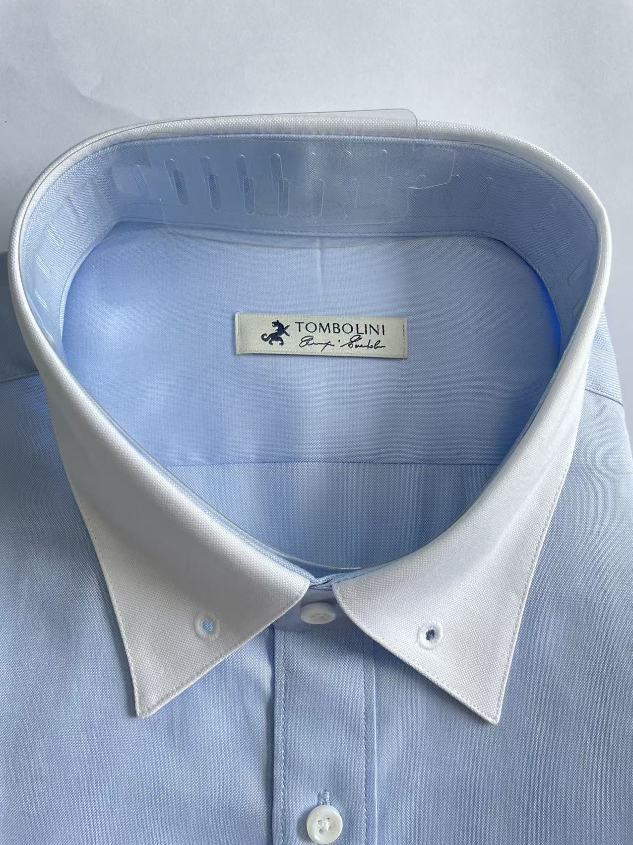Shirts packed with collar support accessories in a garment packaging facility
