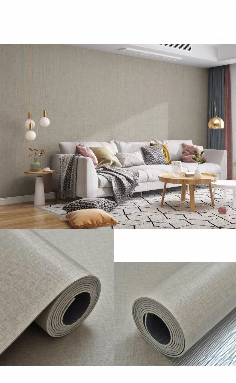 PVC self-adhesive wall sticker being applied to a flat indoor wall with a smoothing scraper
