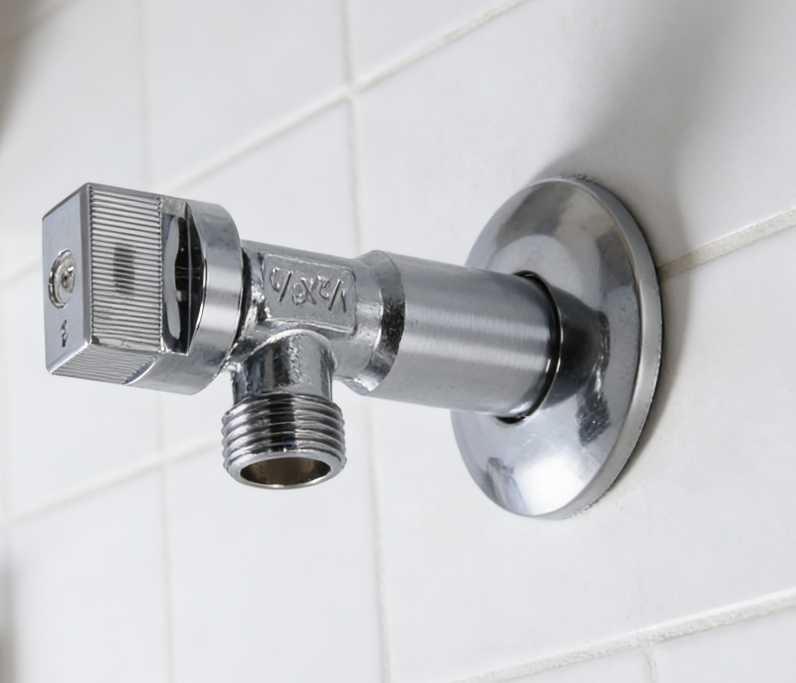 Brass angle valve installed at a bathroom lavatory supply line