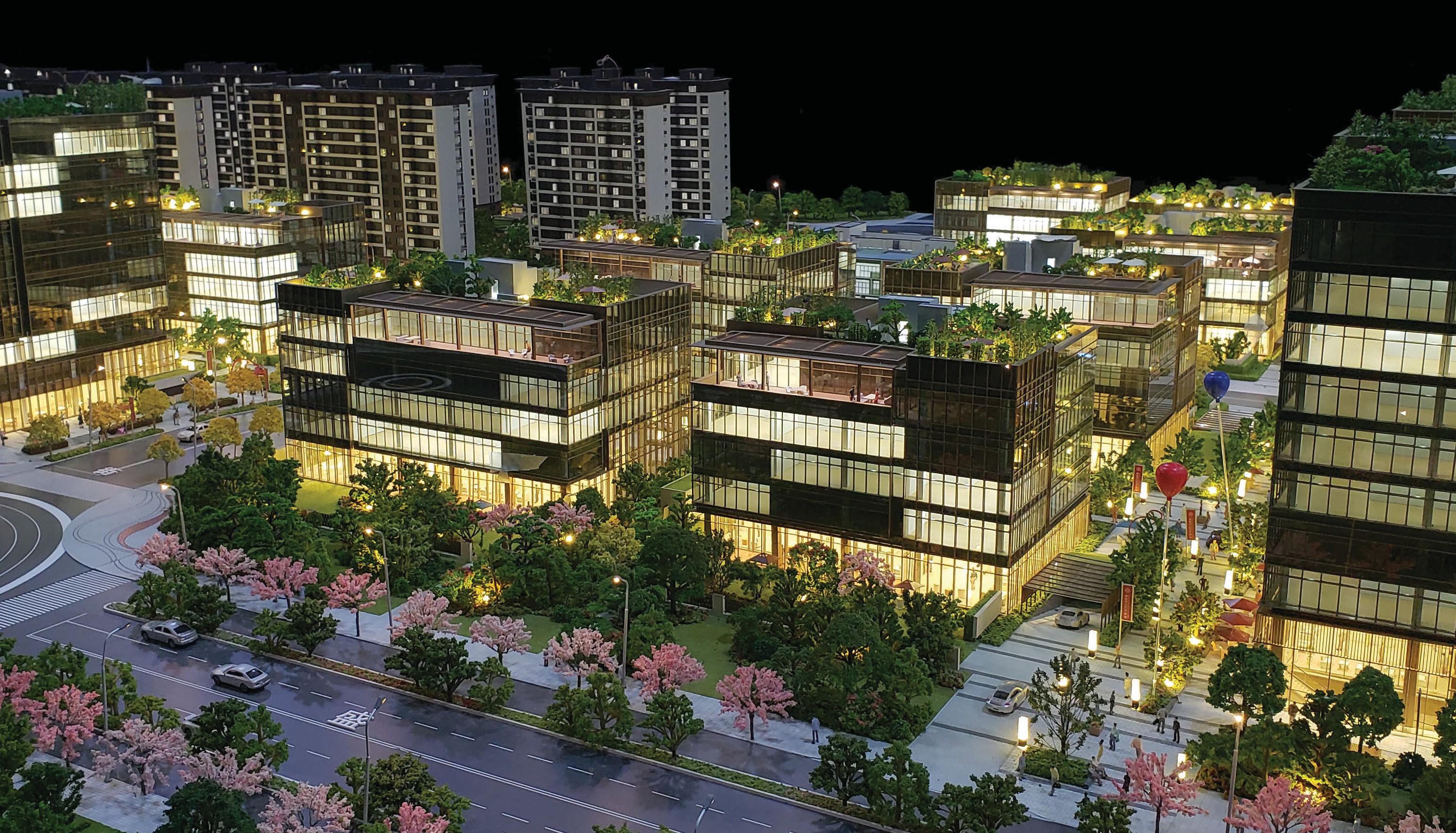 Commercial building window display model showing office complex massing, facade detail and surrounding landscape