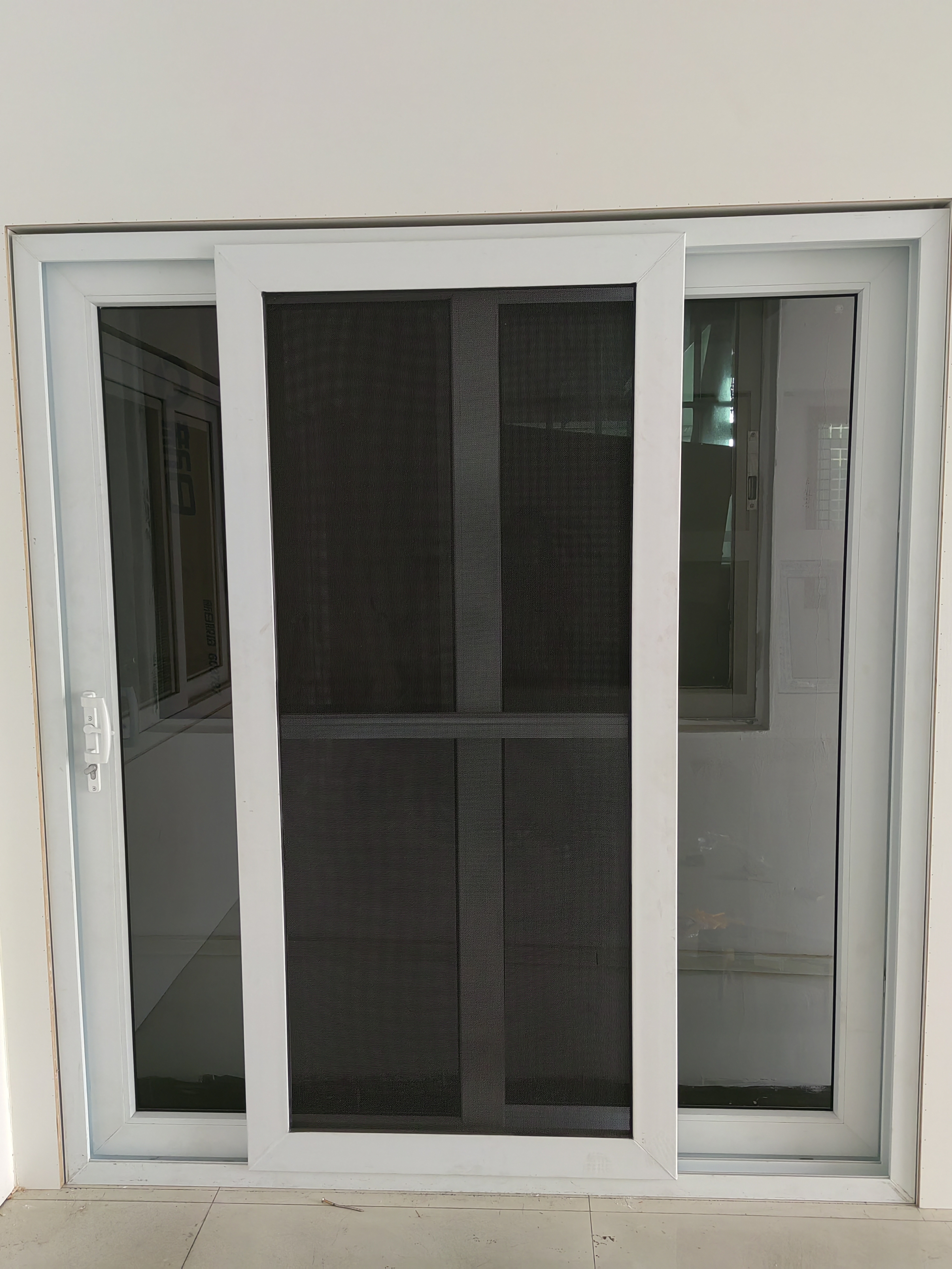 UPVC 112/88-Series sliding door with integrated fly screen, illustrating lateral sash travel shared by sliding and lift-and-slide UPVC door configurations