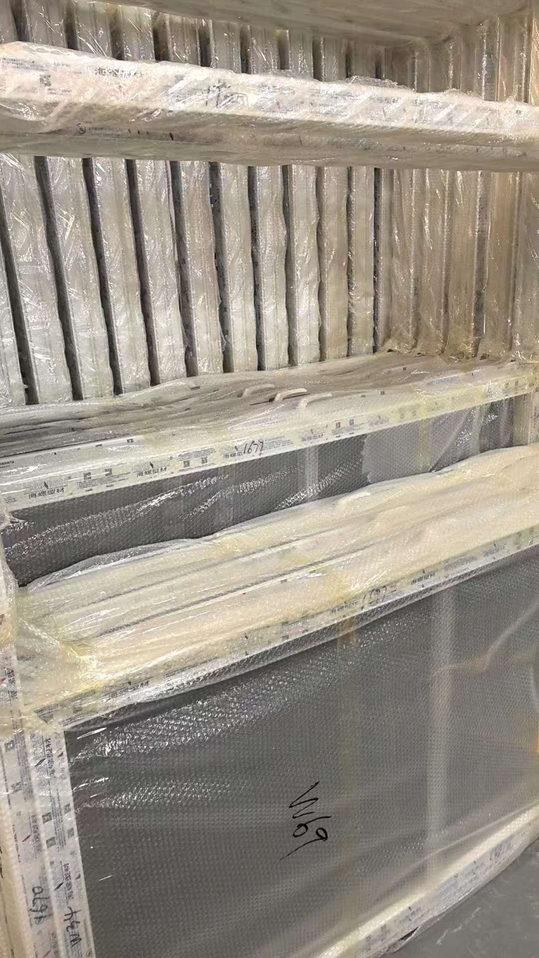 Finished UPVC door units fully packed for export dispatch at a Foshan UPVC door factory