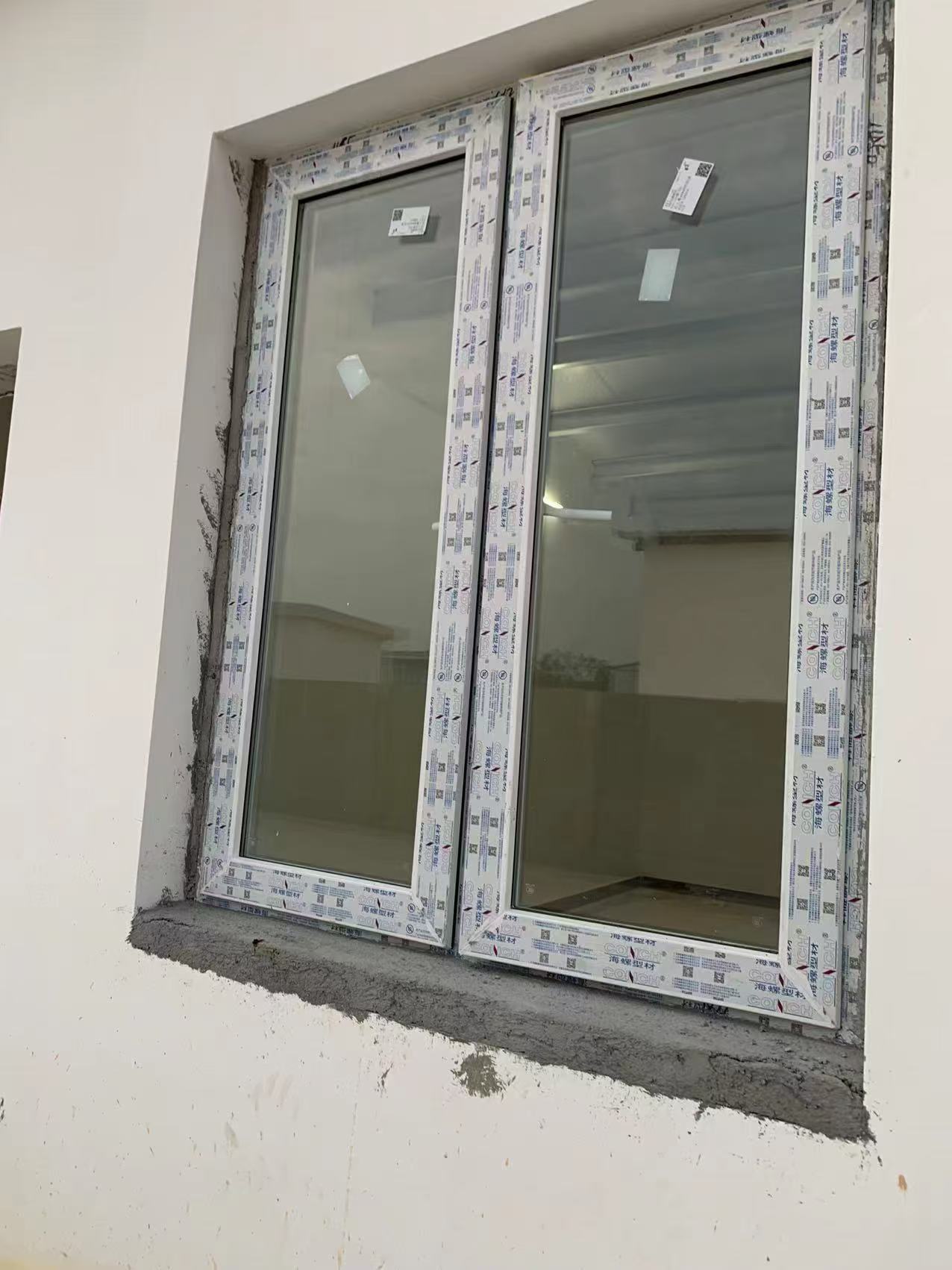 Field-installed UPVC 60-series casement windows on a completed building facade