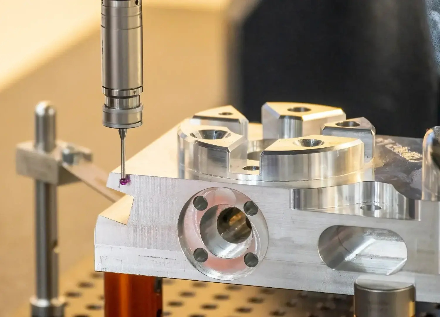 Coordinate measuring machine probe measuring discrete points, shown for comparison with full-field 3D scanning
