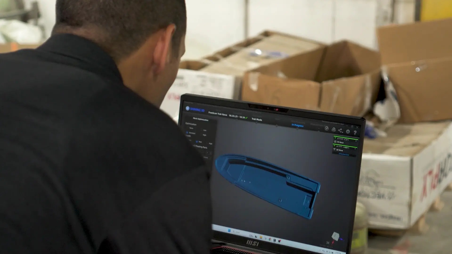 Marine engineer reviewing 3D scan data of a boat hull captured on site