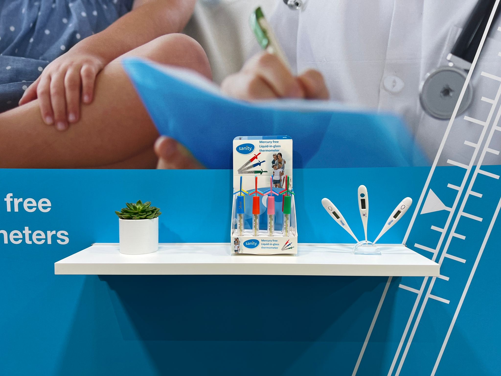 Clinical thermometer exhibition booth display showing mercury-free glass and electronic thermometer formats