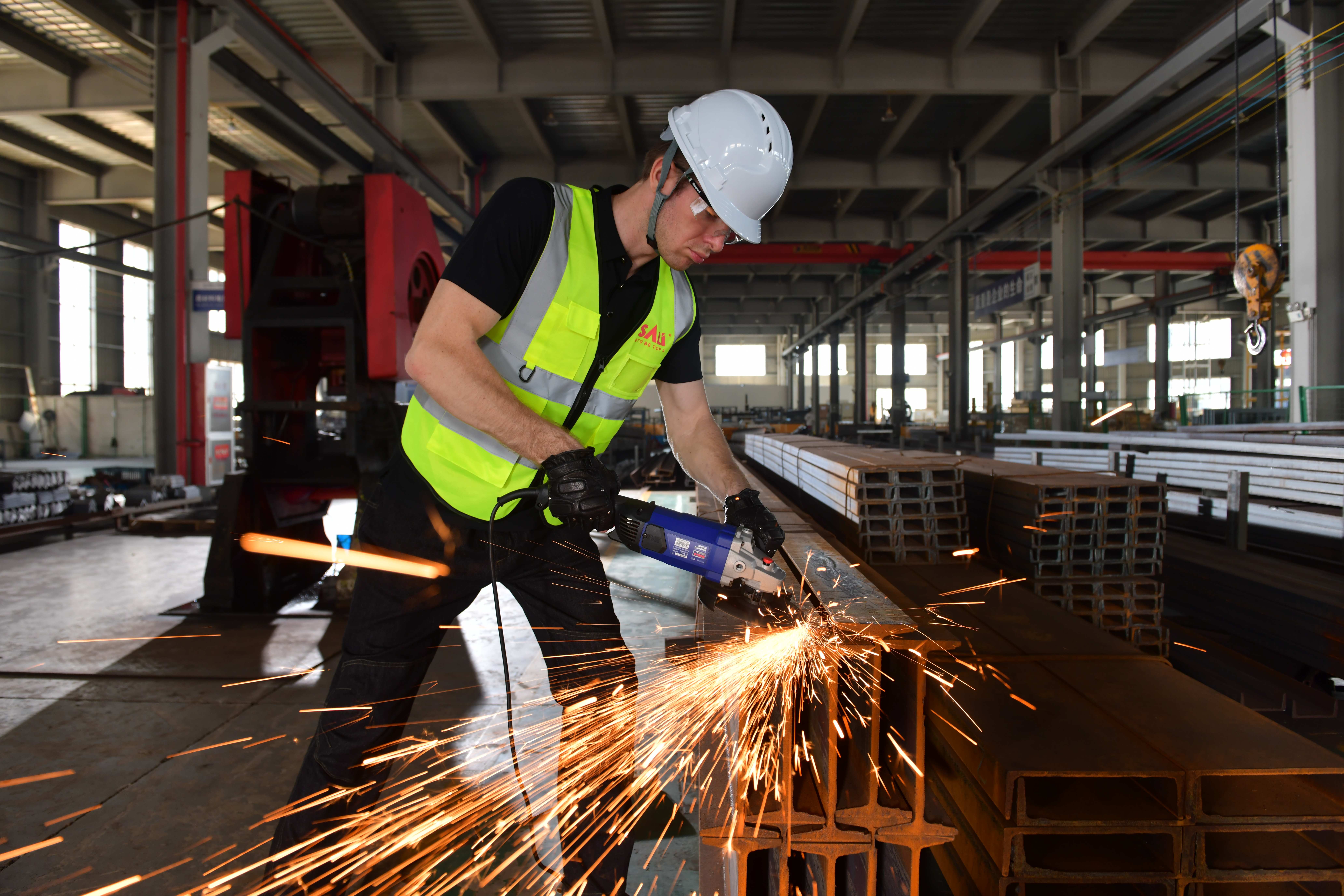 Metal grinding disc in use on an angle grinder during steel fabrication