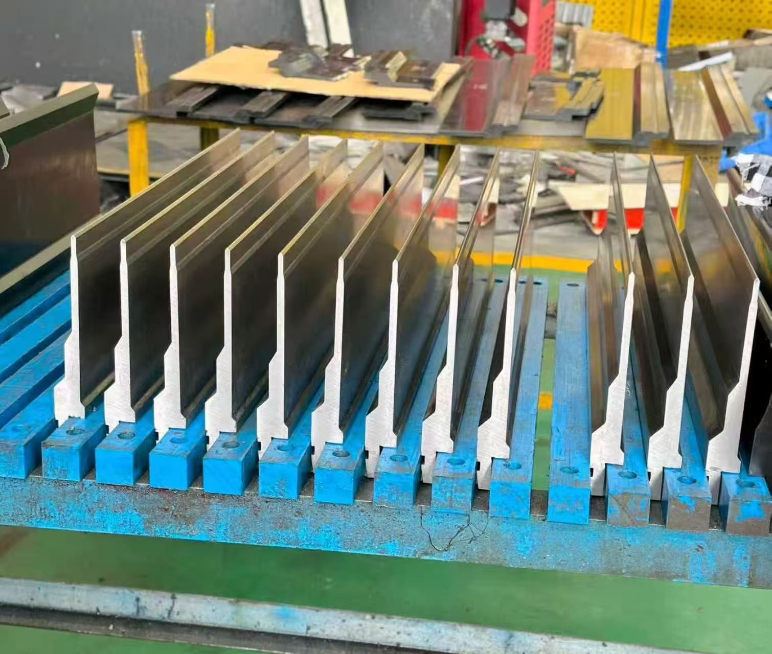 Press brake tooling punches and dies set out for bending operations on a CNC press brake