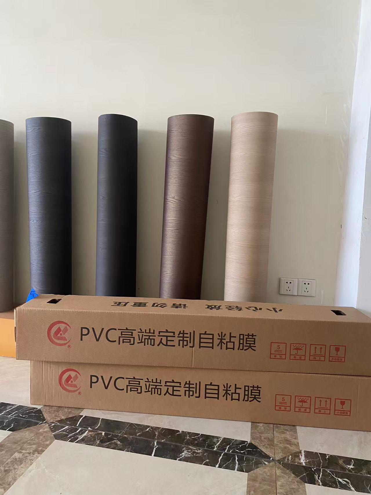 Roll packing and label configuration for self-adhesive PVC decorative film supplied one roll per carton