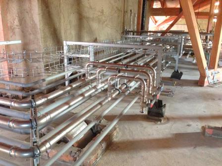 Technician using press tool to install stainless steel press-fit fittings
