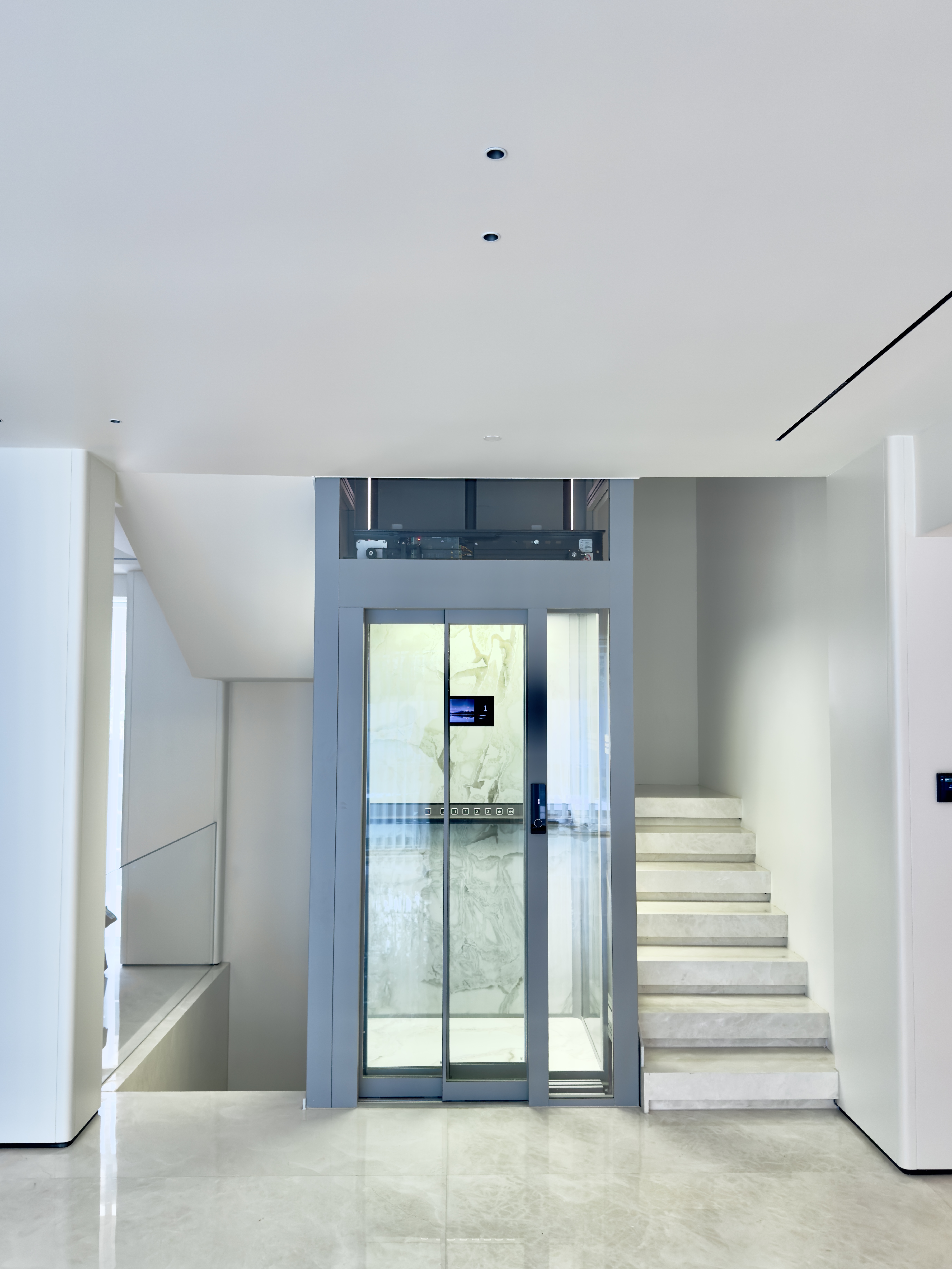 Panoramic home elevator with a 270 degree tempered laminated safety glass cabin installed in a duplex residence