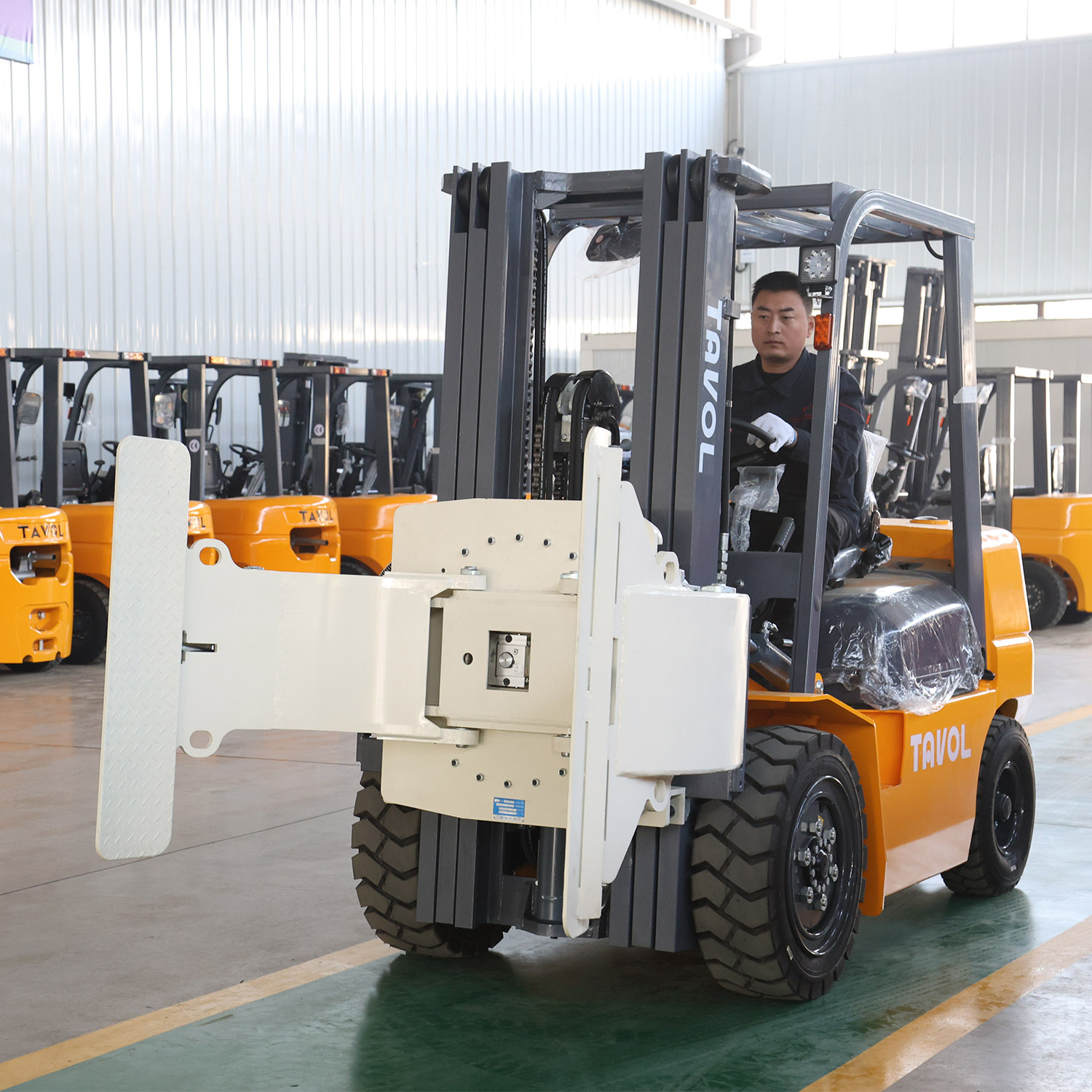 Forklift with paper roll clamp in paper mill warehouse