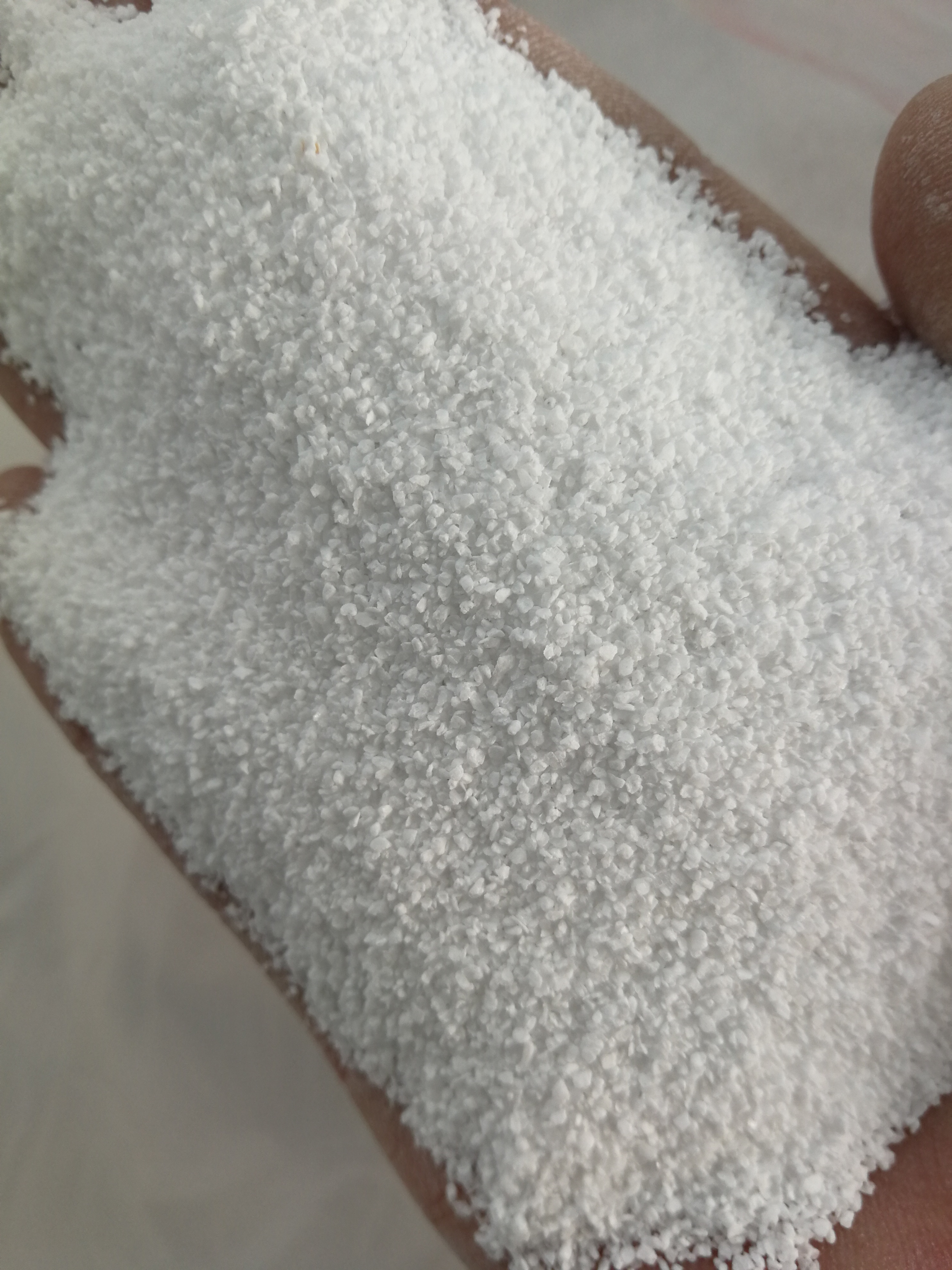 White potassium aluminium fluoride in granular form