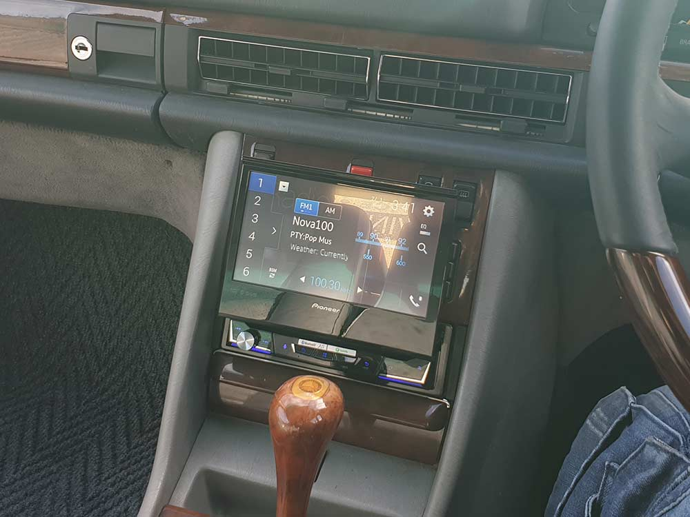 Aftermarket Android head unit installed in a factory dashboard using a vehicle-specific fascia kit, showing a flush factory-style finish