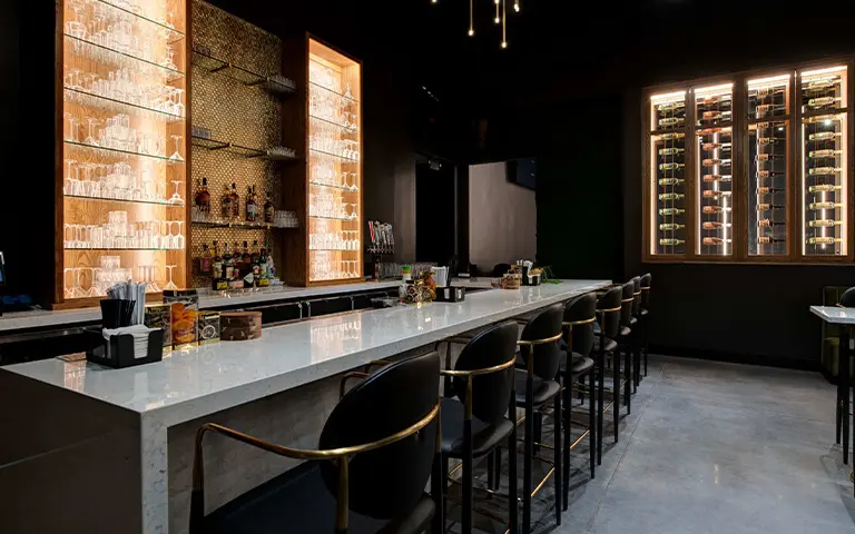 Custom upholstered commercial bar stools in a coordinated restaurant and bar furniture package