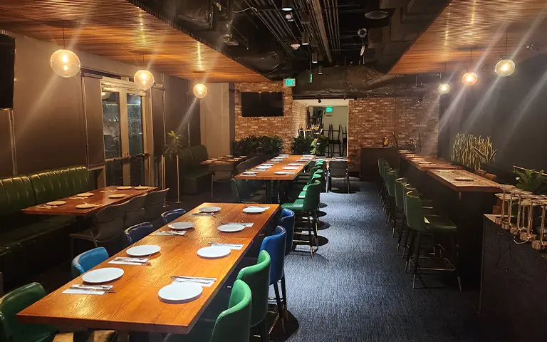 High dining tables and table bases in a multi-zone restaurant and entertainment venue