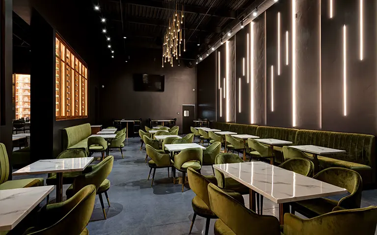 Green velvet restaurant furniture booth seating in a commercial charcuterie lounge project