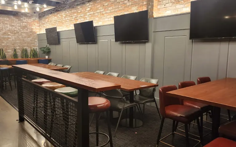 Long communal dining tables and freestanding bases arranged for group dining and events