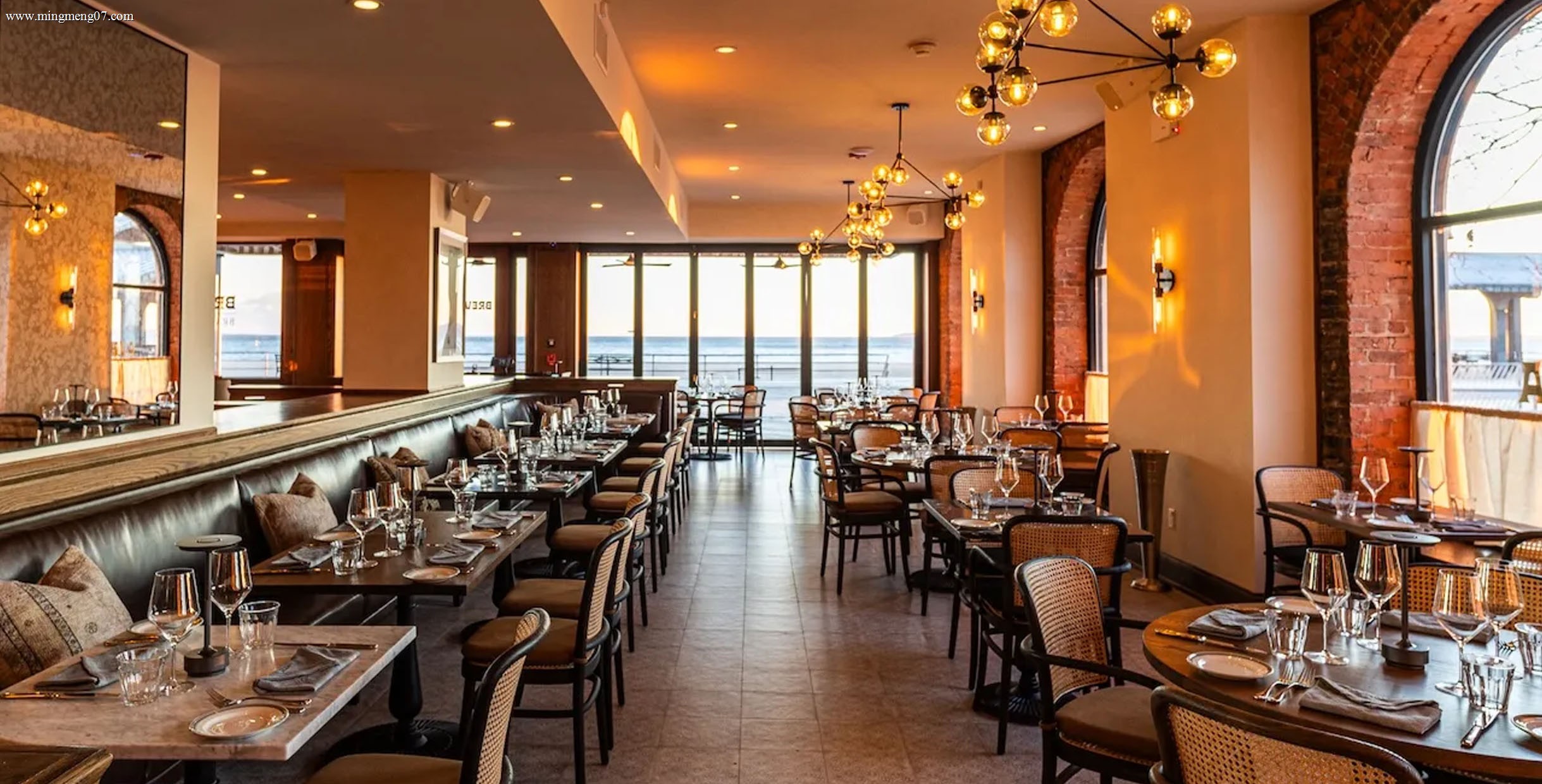 Restaurant set with dining table and rattan chairs beside large windows