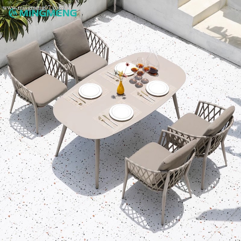 oval-outdoor-table-with-wicker-armchairs