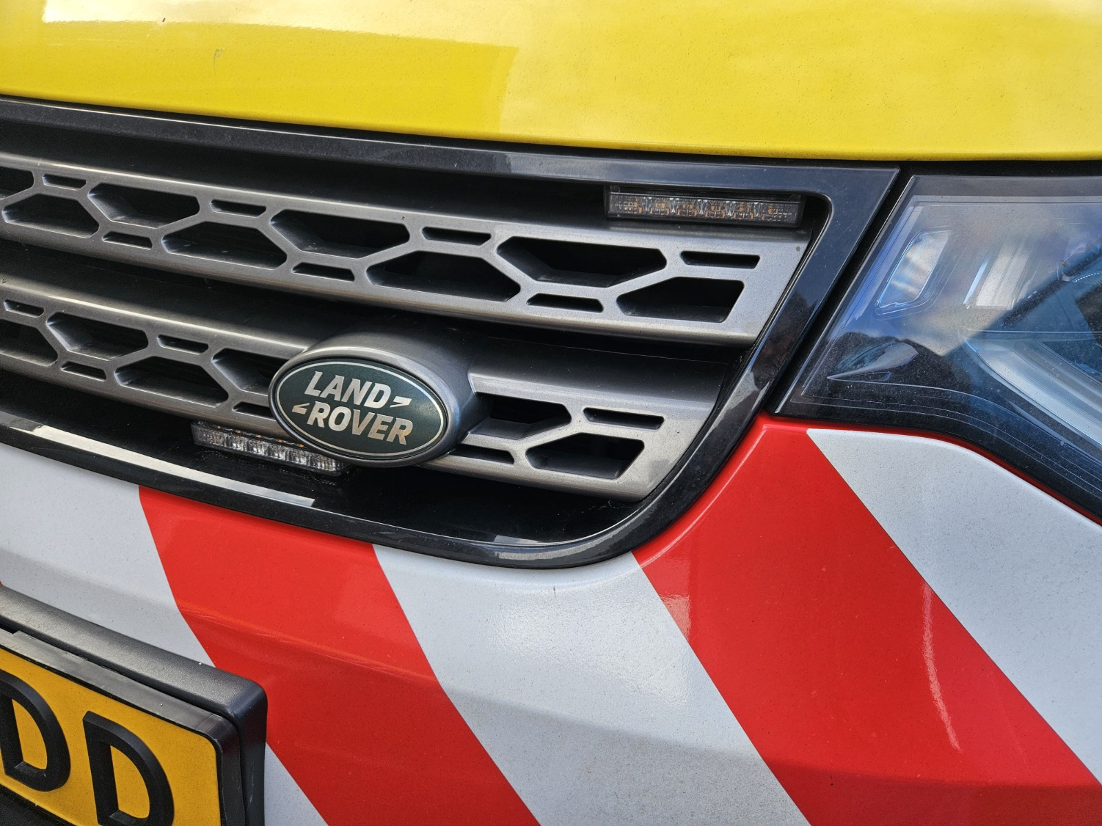 Grille-mounted LED warning light installed on a service vehicle