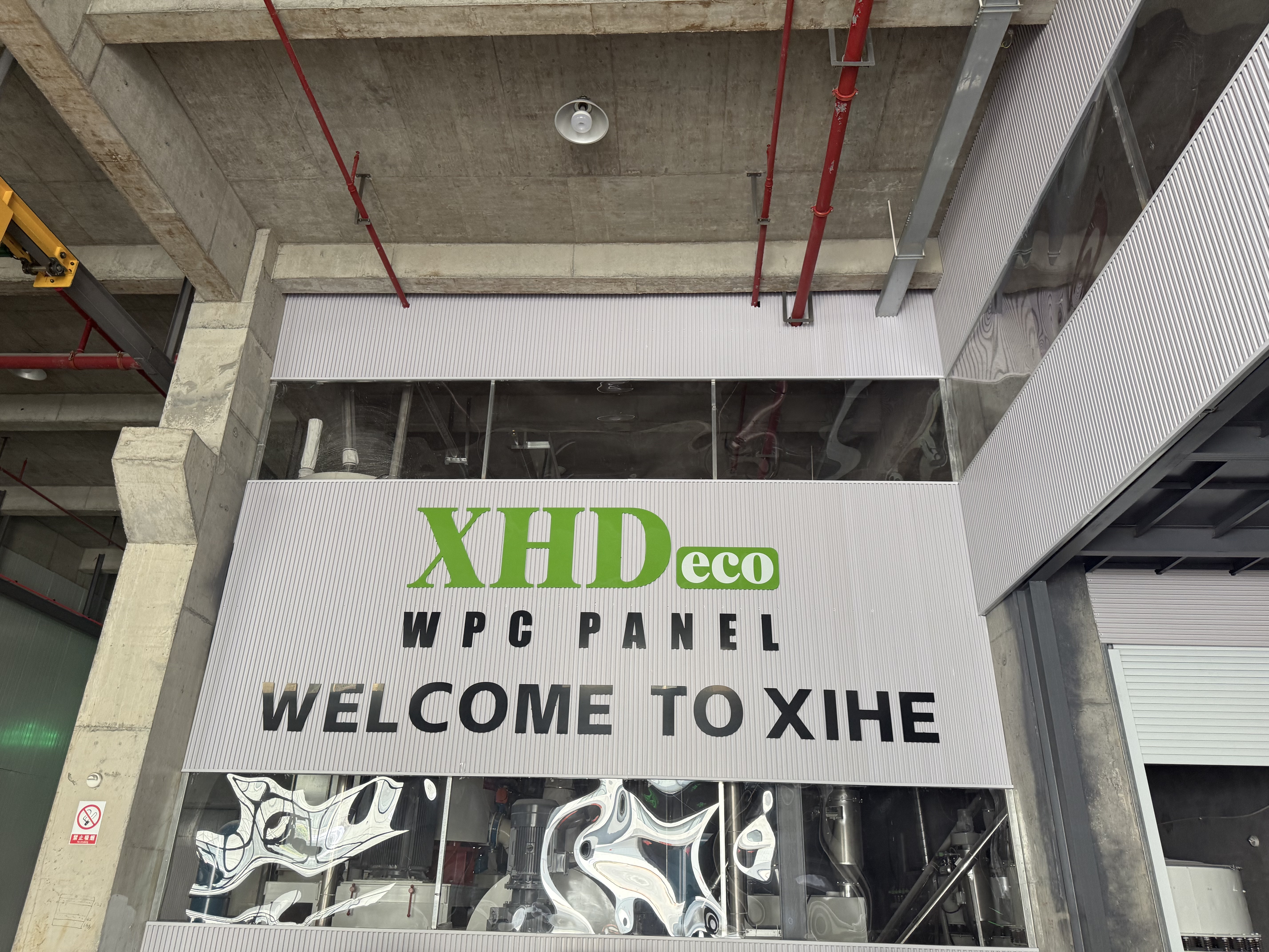 WPC and PVC decorative panel production area at a building materials factory in Haining, Zhejiang