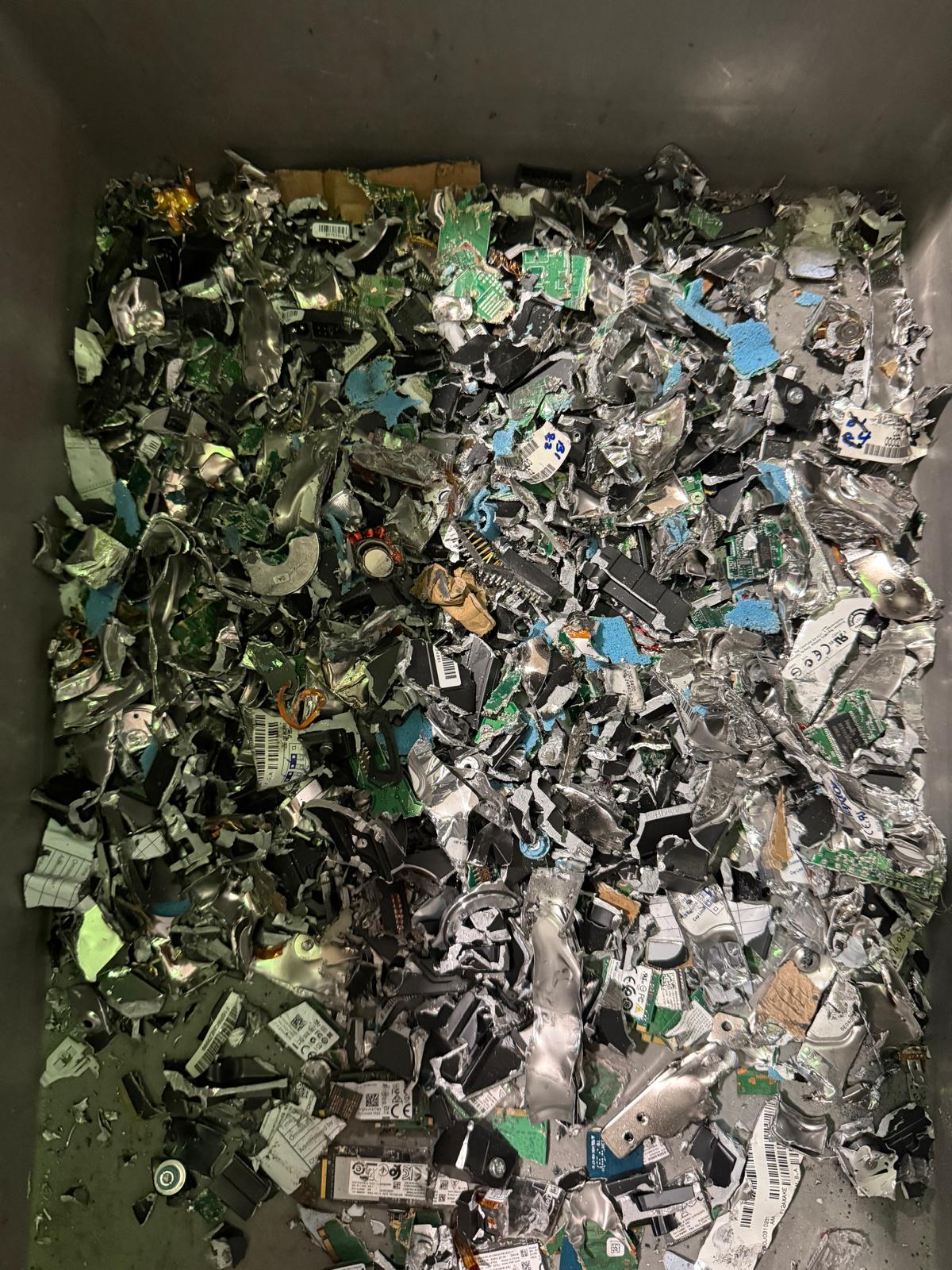 Hard disk drive after physical destruction, showing destroyed platter assembly