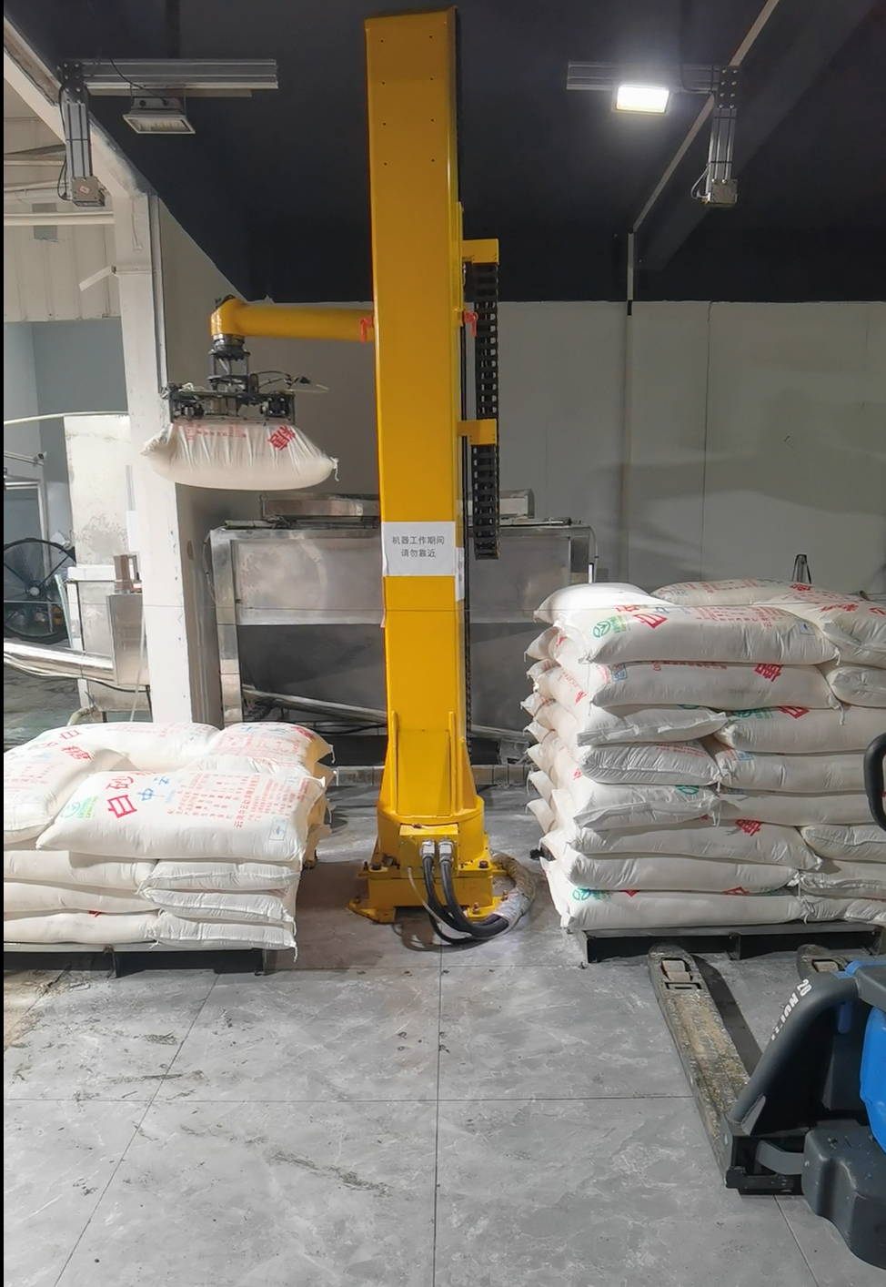 Depalletizing and bag breaking industrial robot cell with vision system and bag cutting mechanism