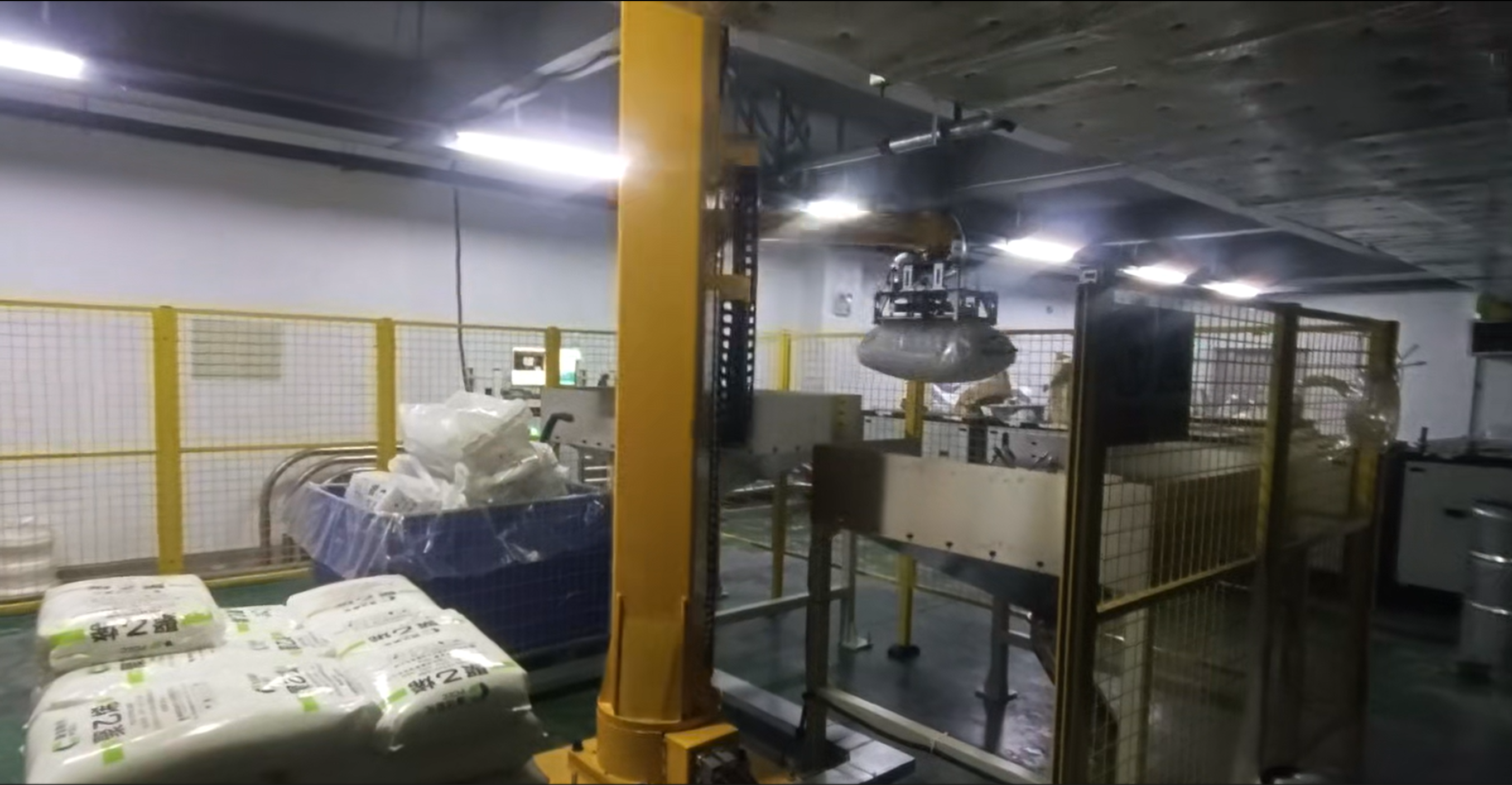 depalletizing and bag breaking industrial robot cell used for bagged raw material handling