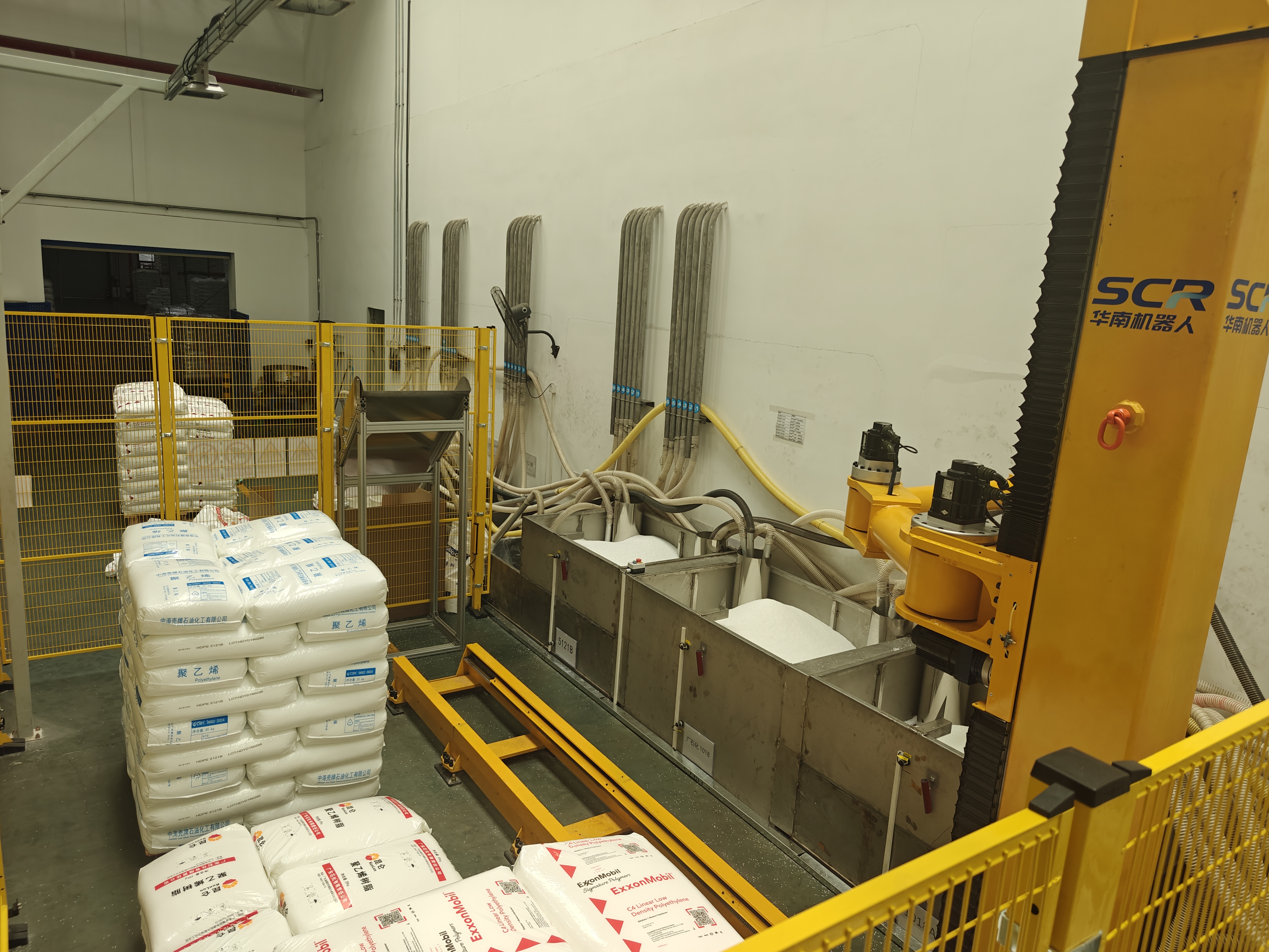 Depalletizing and bag breaking industrial robot working on a production line