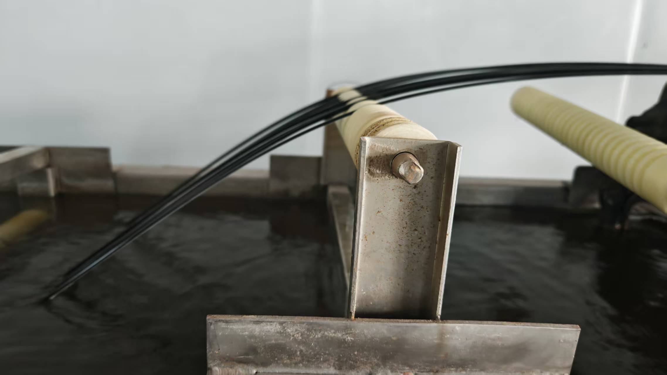 Water-cooling stage following extrusion in the WanHan modified plastic pellet production line.
