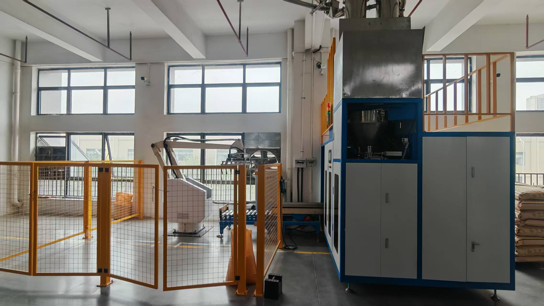 Automatic weighing and packaging line for WanHan modified plastic pellets.