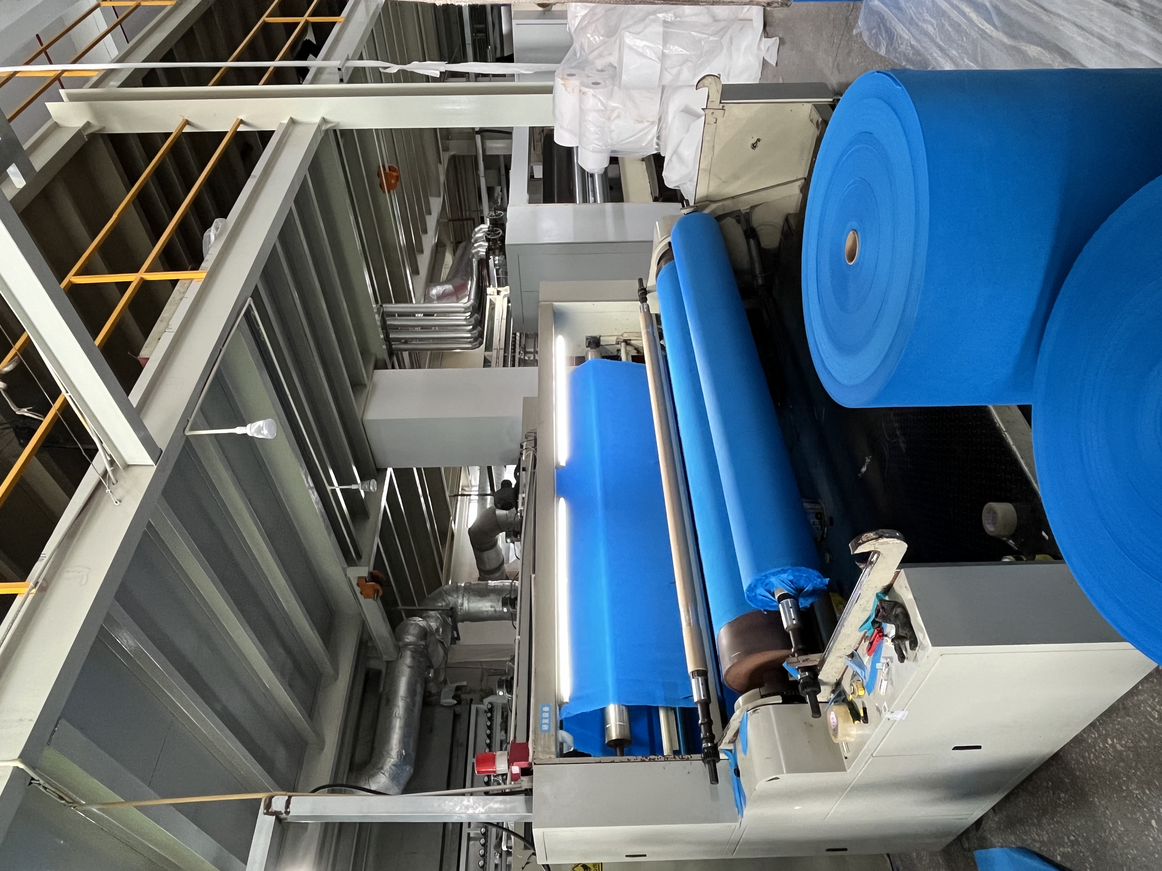 Runjiang Fabric Production Line - fabric processing equipment and material rolls at Zhejiang Runjiang New Material Technology Co., Ltd.