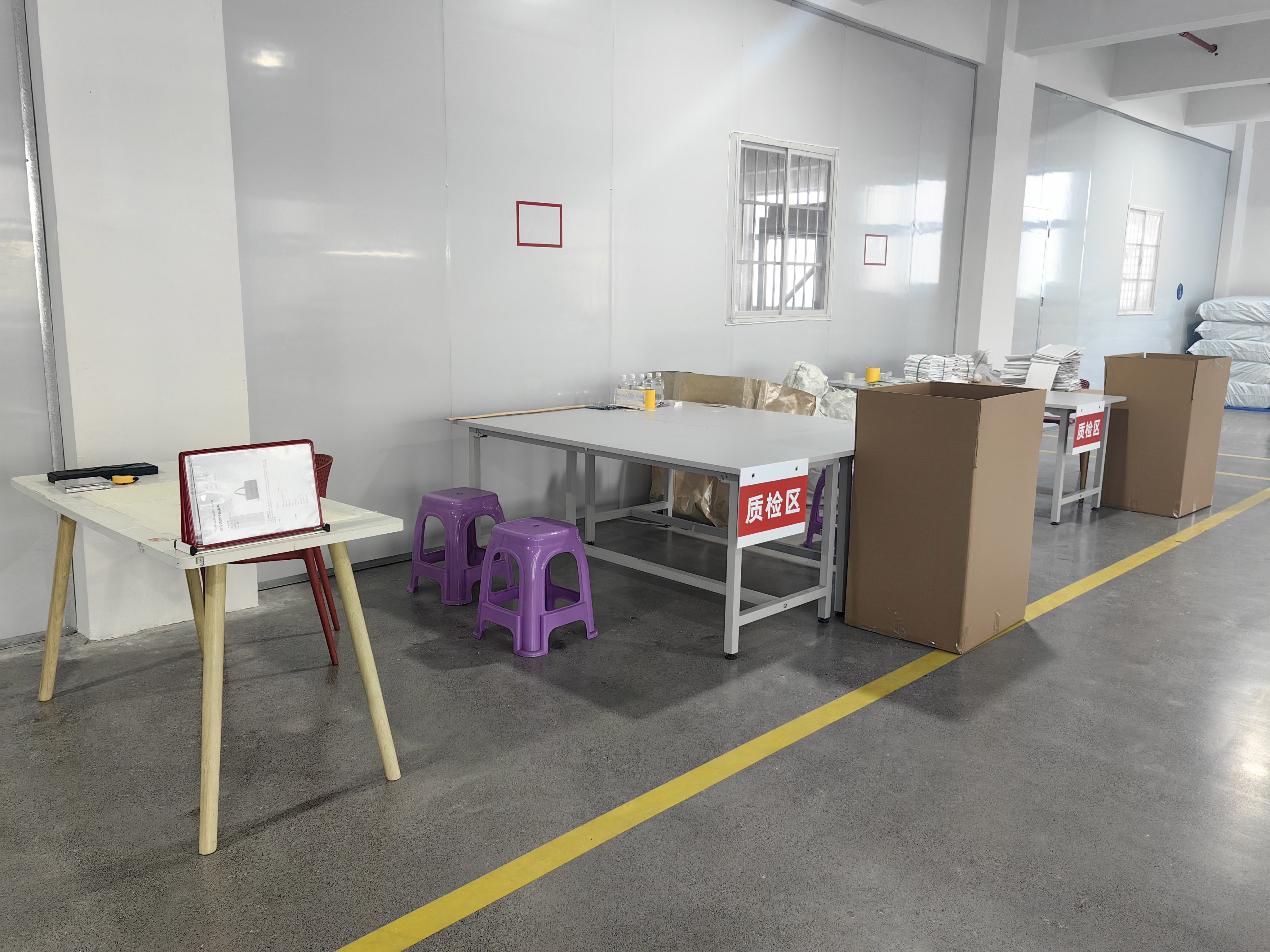 Quality inspection area with inspection tables used for incoming material and finished-product checks at the manufacturing facility