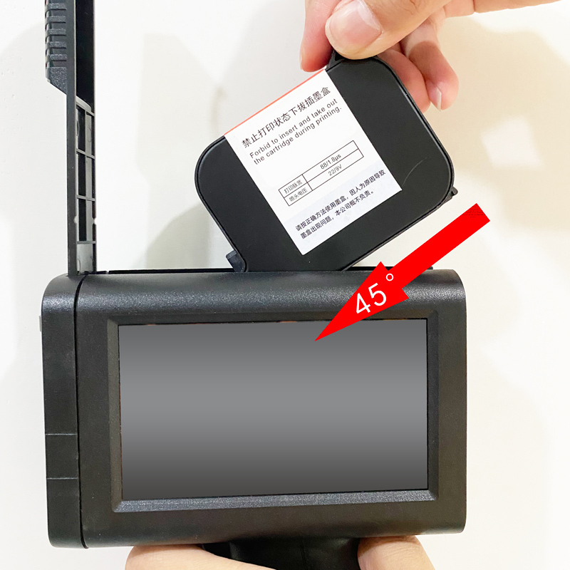 Pushing the lever up to secure a handheld TIJ ink cartridge flush with the M10 machine body