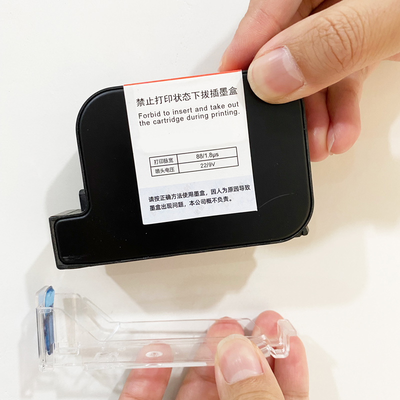 Inserting a handheld TIJ ink cartridge at a 45-degree angle into the M10 cartridge compartment
