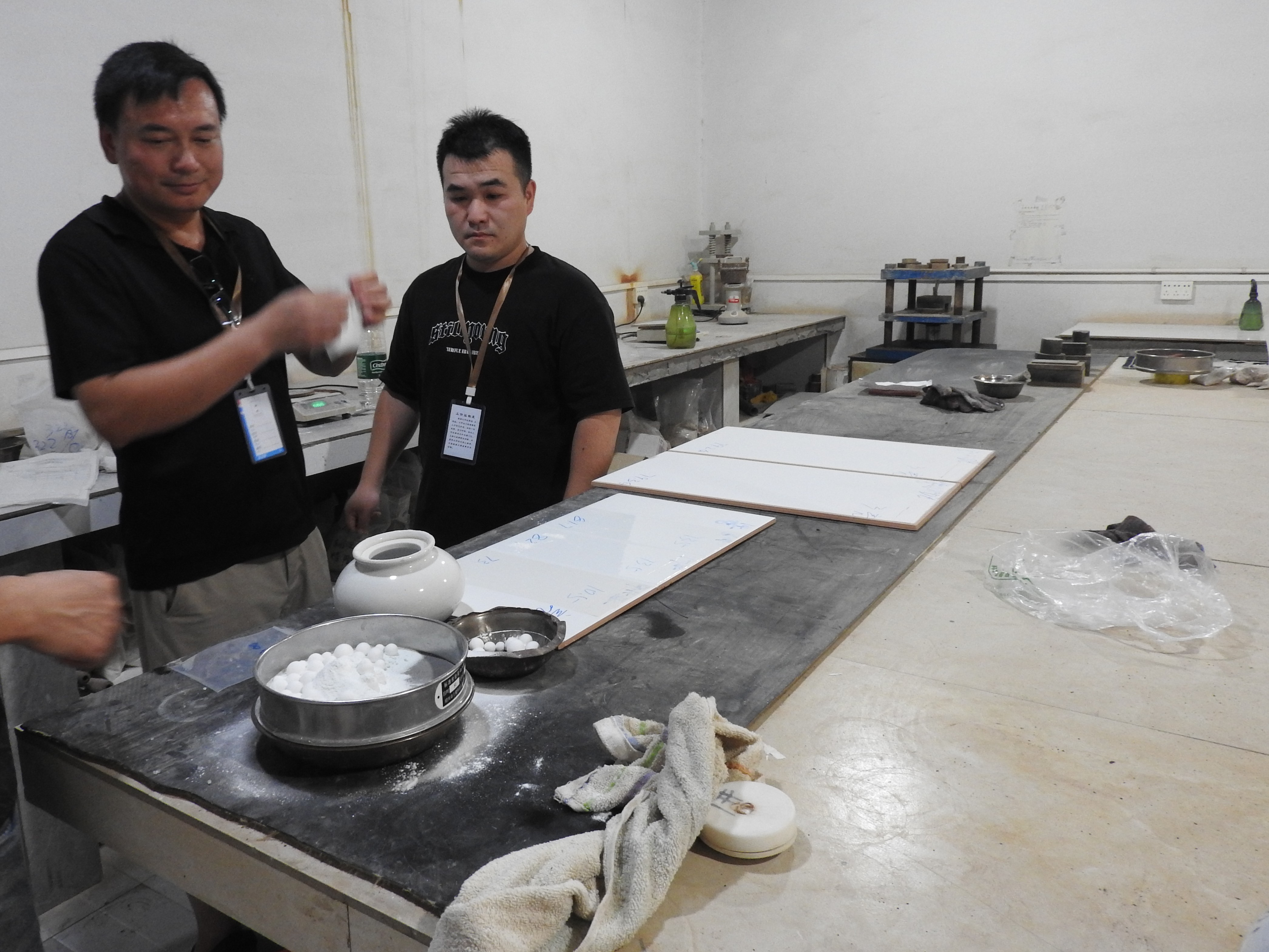 RENOVA technicians testing and optimising titanium frit performance at a customer ceramic tile factory
