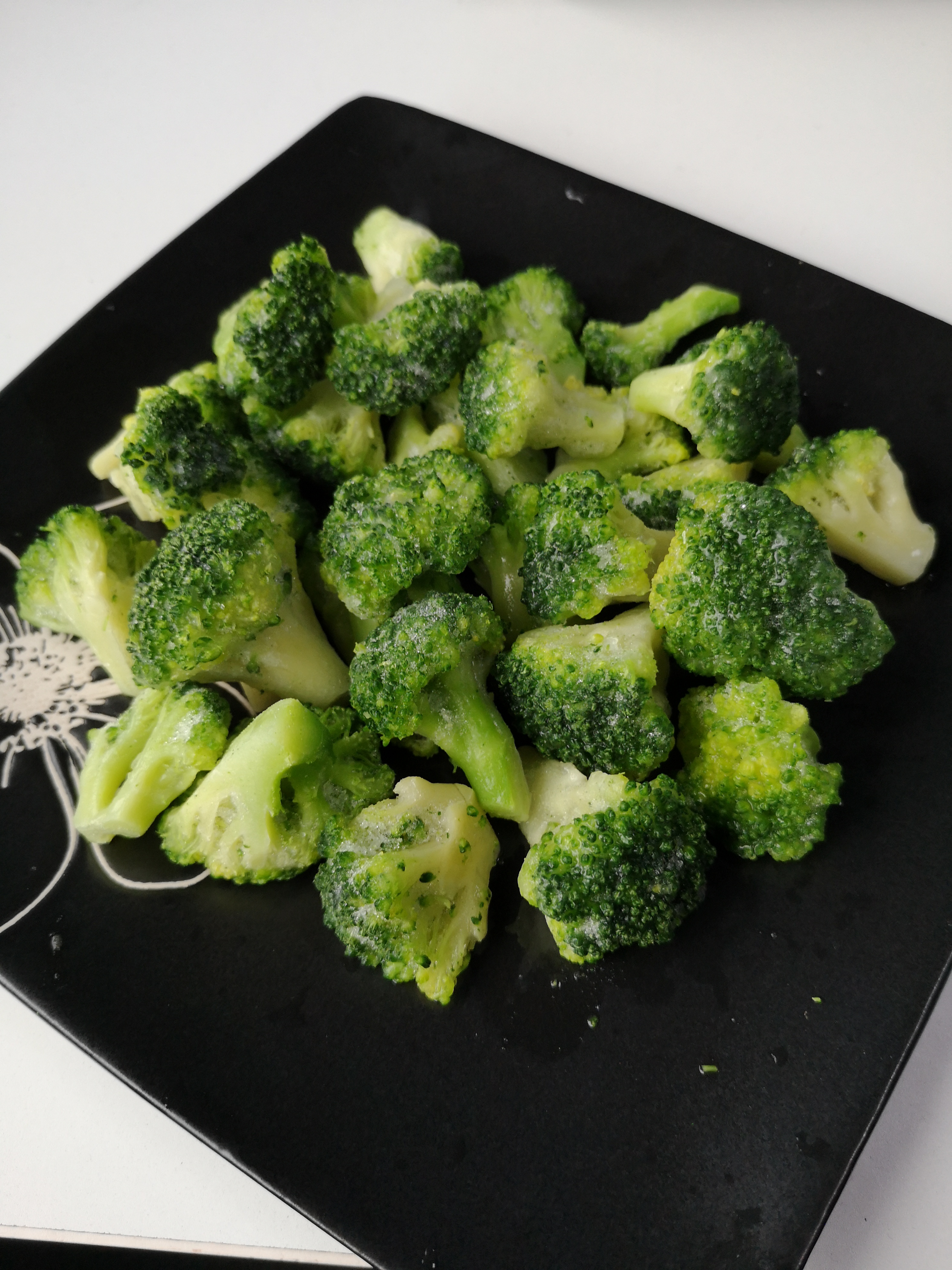 Frozen broccoli is displayed on the plate