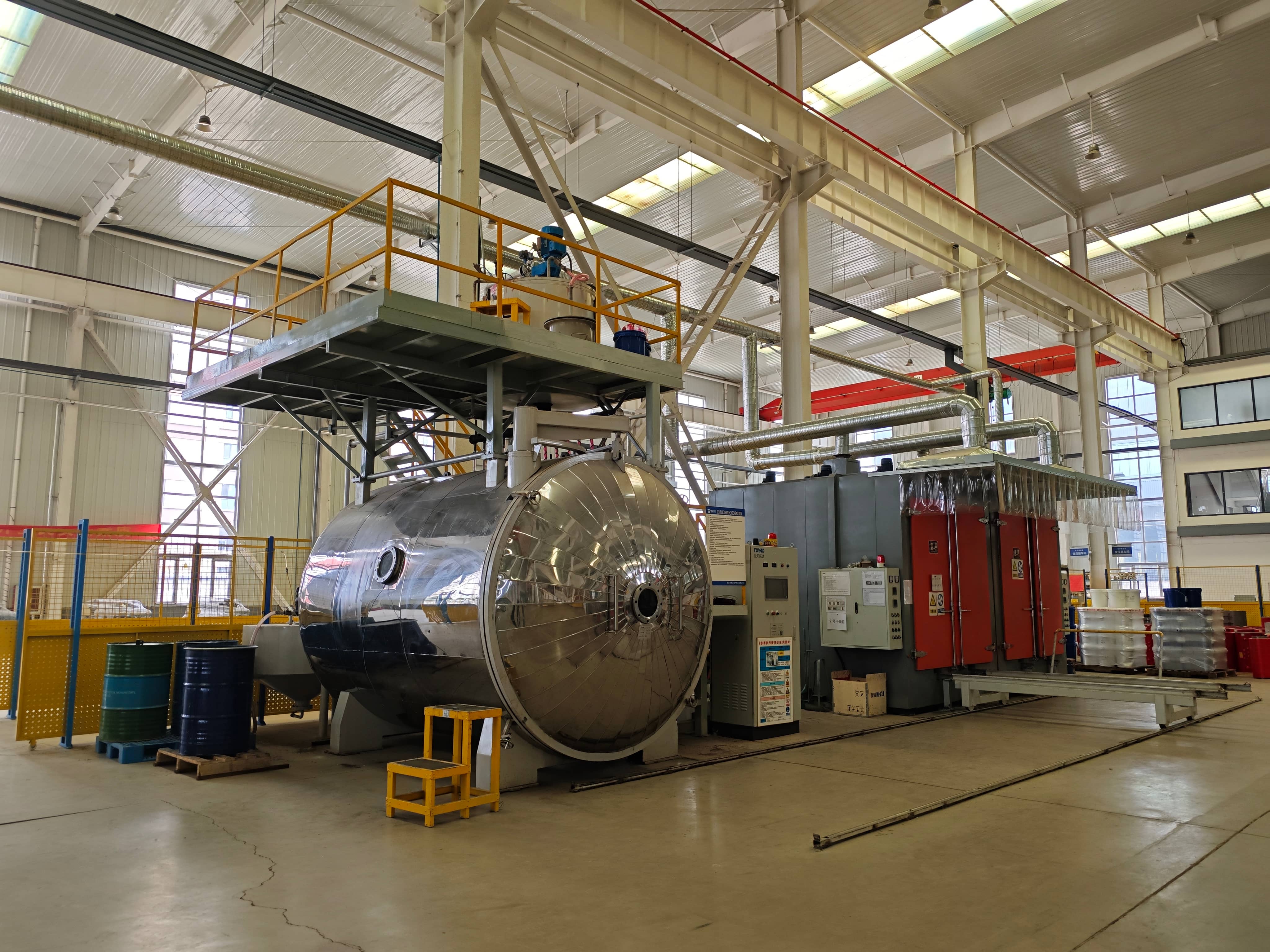 Transformer drying and insulation resin casting equipment in the manufacturing workshop. The equipment is used for moisture removal, insulation treatment, and resin casting processes during transformer production, including insulation processing for dry-type transformer components.