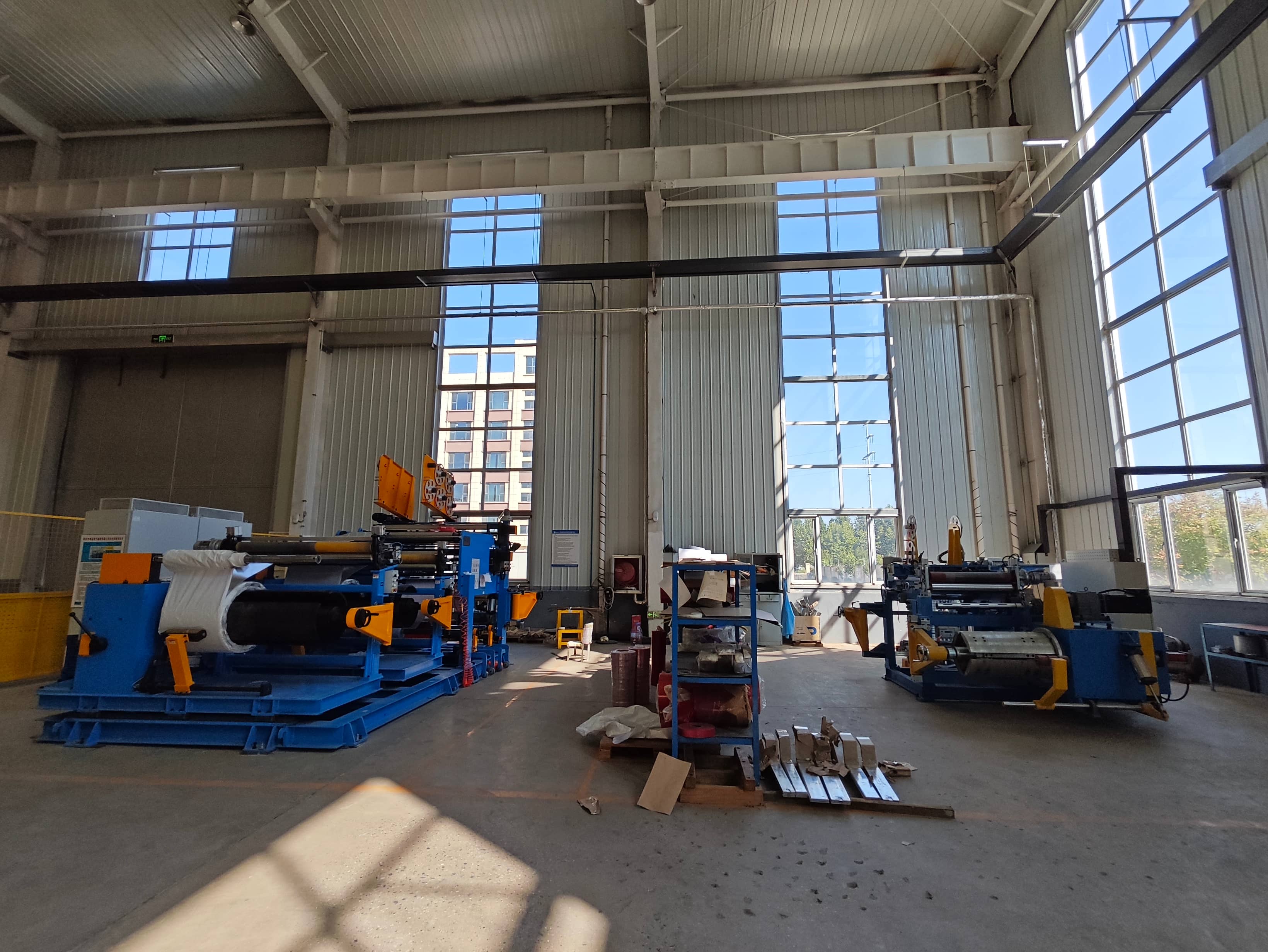 Transformer foil winding machine used to manufacture transformer coils and windings. The machine winds conductive foil with insulation materials to produce windings for power and distribution transformer applications.
