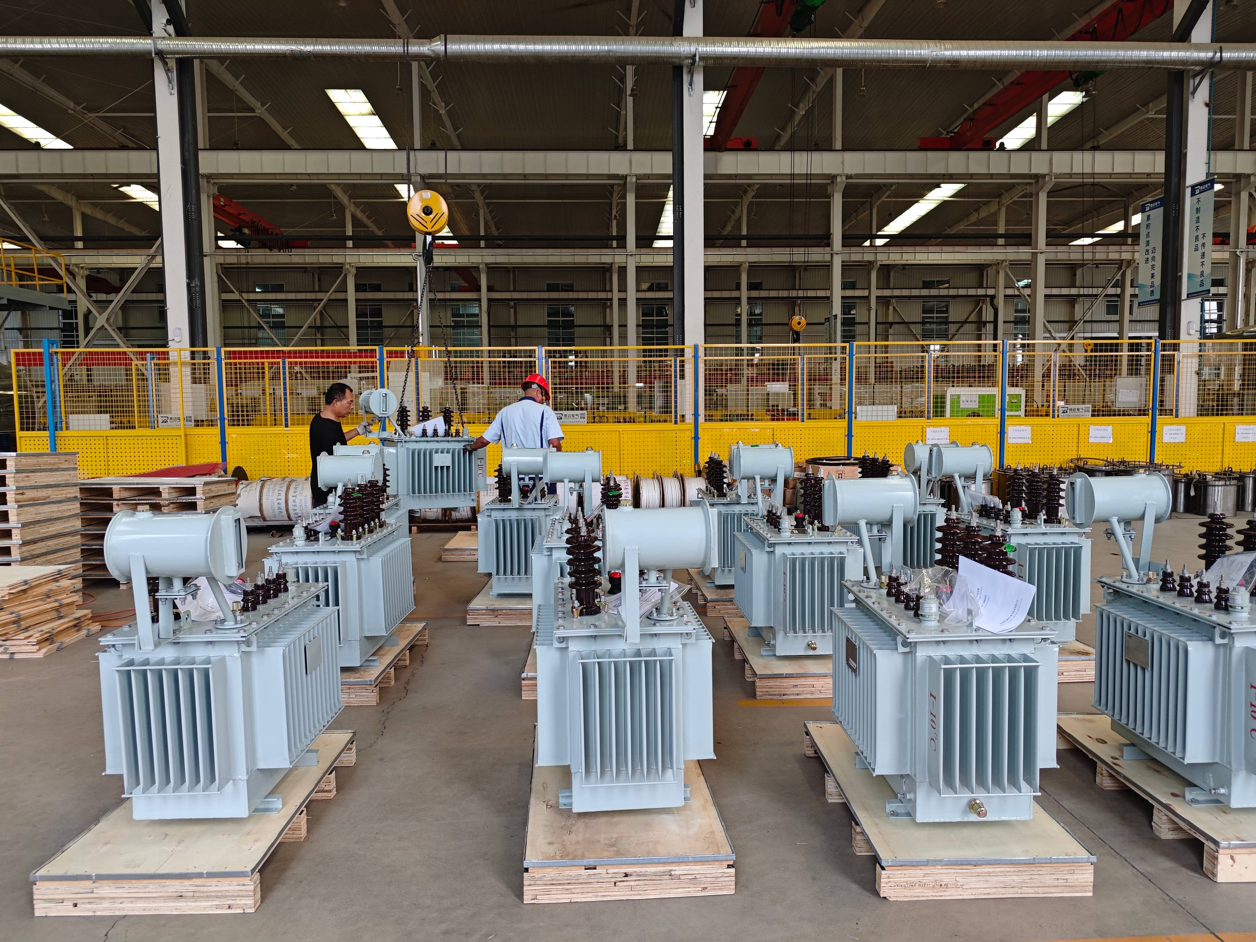 Finished transformers stored in the factory warehouse before packing and shipment. Completed units are arranged in the dispatch area for final handling, packaging, and transportation preparation according to order requirements.