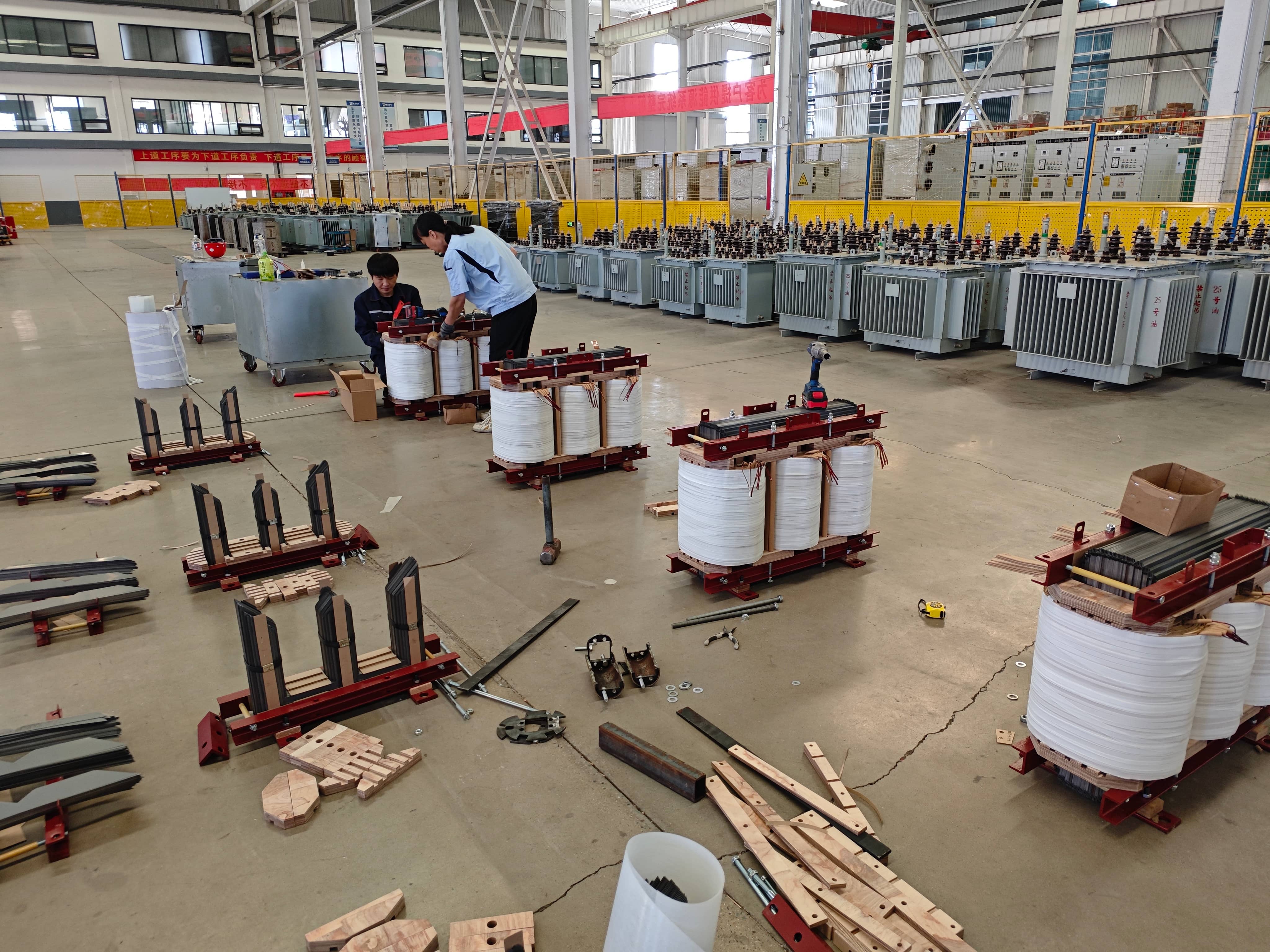 Transformer coil winding process at Milestone Electrical's manufacturing workshop, where conductor windings are produced for oil-immersed distribution transformers. Winding production involves conductor arrangement, insulation placement, and coil forming according to transformer design specifications, forming a key stage in power and distribution transformer manufacturing.