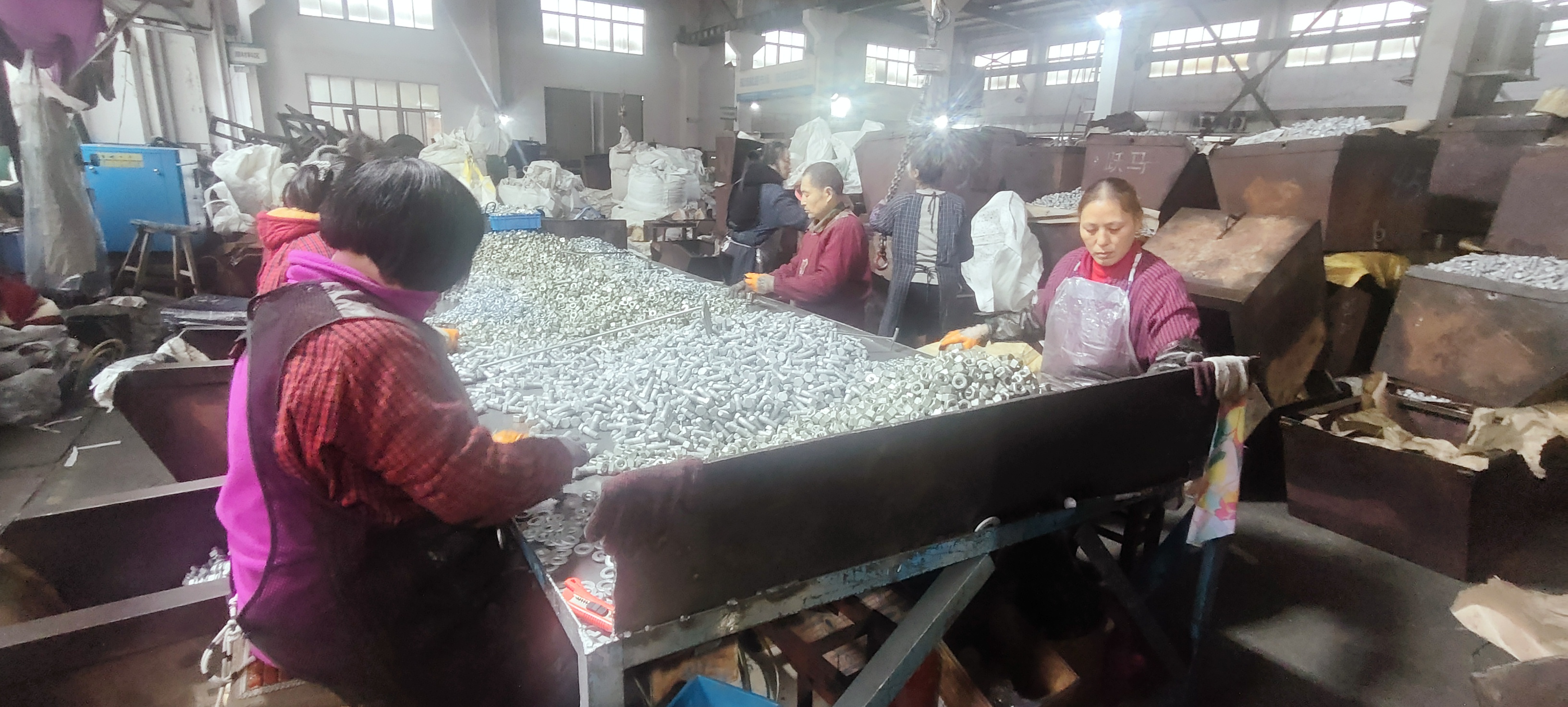 Tower bolt assembly operation at a fastener manufacturing facility in Ningbo, China