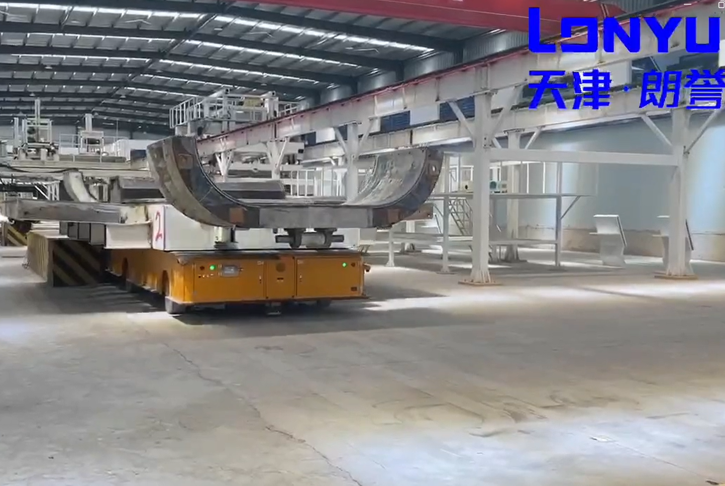 Heavy duty AGV transporting a wind power component in an outdoor industrial yard